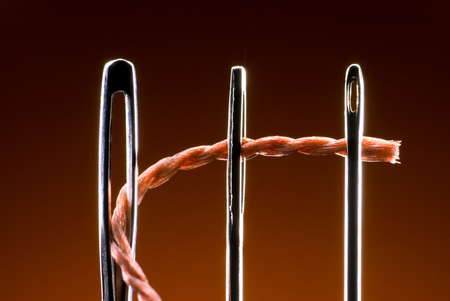Three metal needles and kapron string  Very much a close up  Art background の写真素材