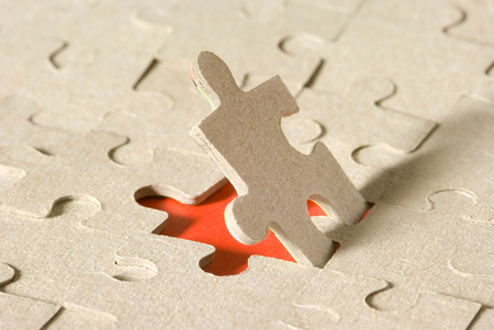 Paper puzzles on a red background  One puzzle is open の写真素材