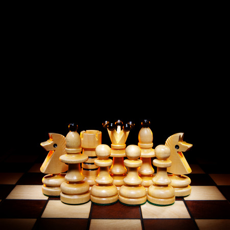 Chessmen on a chess board  A dark background and art illumination の写真素材