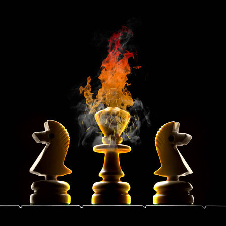 Chessmen  king and two horses   King burns on a black background の写真素材
