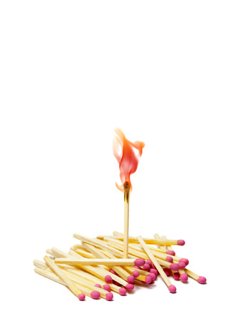 A lot of matches on white isolated background  A match is lit の写真素材