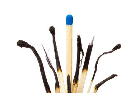 Many the spoiled matches on a white isolated background  One match the whole の写真素材