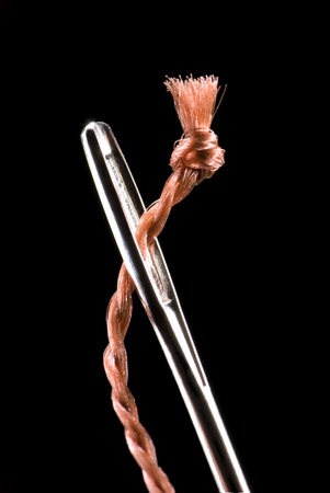 Metal needle and string  Very much a close up Black background の写真素材