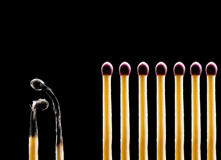 Matches on a black background  Two matches the spoiled and seven whole の写真素材