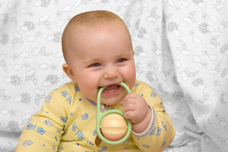 A cute baby biting toyの写真素材