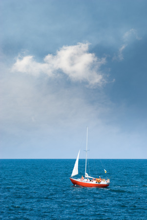 Crimea, the Black Sea. A lone sailboat, and storm clouds.????????? ????????? ???????? ?????? ????????? ????????? ???????? ?????? ?????????????????????????????A lone sailboatCrimea, the Black Sea. A lone sailboat, and storm clouds.の写真素材