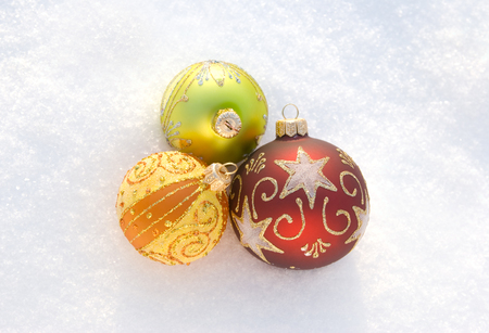 Three beautiful decorative spheres on a white snowの写真素材