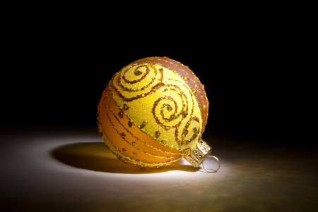 Yellow decorative sphere on a dark art background.の写真素材