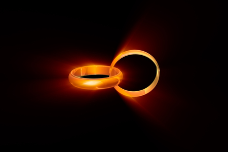 Two wedding rings on a black background. Used a glow effect.の写真素材