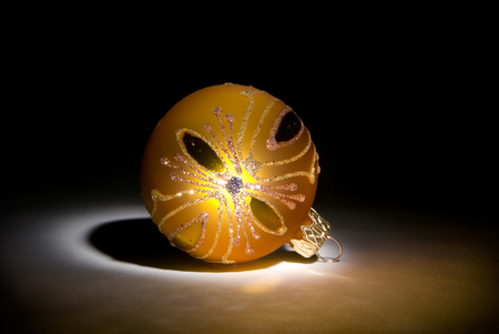 Yellow decorative sphere on a dark art background.の写真素材