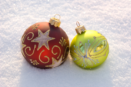 Two decorative spheres on a white snow.の写真素材