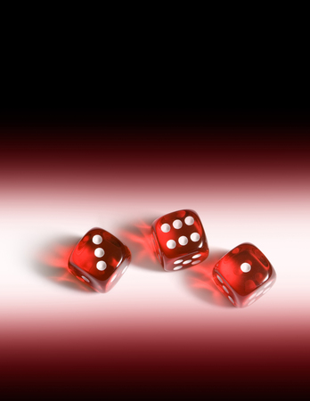 Red glass cubes (three pieces). A dark background.の写真素材