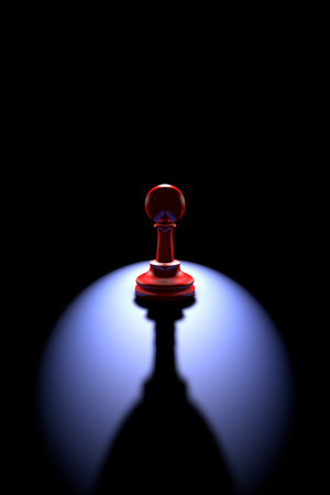 Red pawn silhouette on a dark background art. Backlight and deep shadow.の写真素材