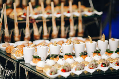 Fall background of food Amazing Lunch Party food Served on plate Catering serviceBlack interior restaurant table with foodの写真素材