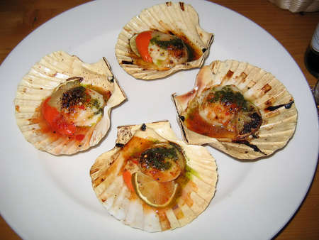 Scallops in Shell with Chili and Lime on a White Plate