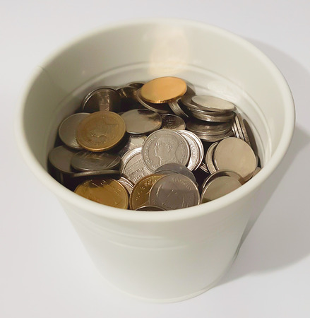 Baht Thai coins in white potの写真素材