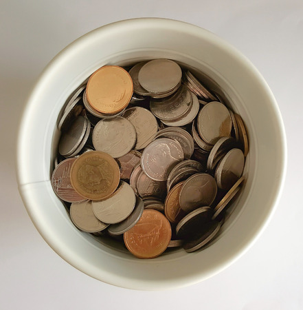 Baht Thai coins in white potの写真素材