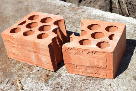 cracked into two halves lying on concrete brickの写真素材