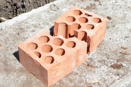 cracked into two halves lying on concrete brickの写真素材