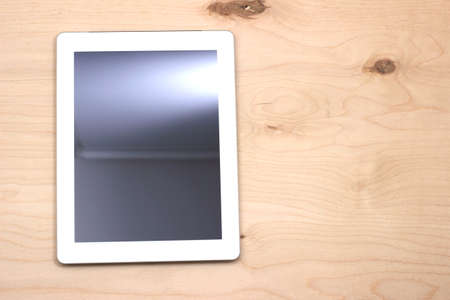 White tablet on wooden tableの写真素材
