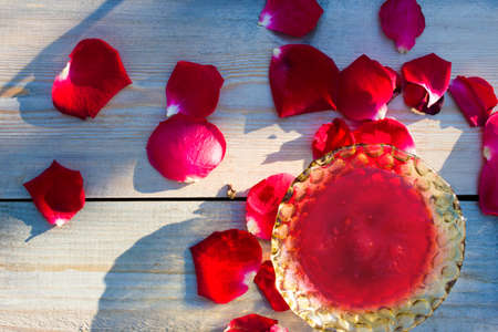 Jam made of rose petals on the wooden background. Freshly made jam.の写真素材