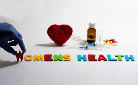 Hand and womens health word on the white backgroundの写真素材