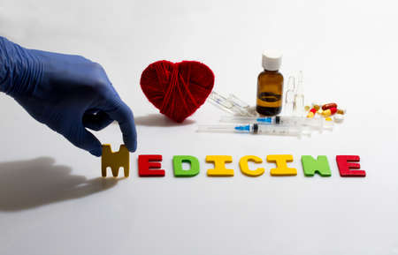Hand and medicine word on the white backgroundの写真素材