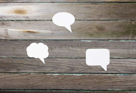 Dialog bubbles. Clouds on a wooden backgroundの写真素材