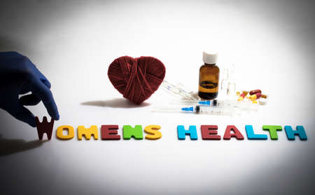 Hand and womens health word on the white backgroundの写真素材