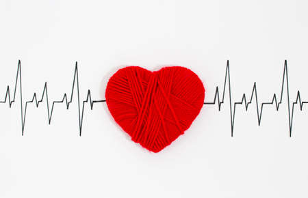 woven red heart on the cardiogramの写真素材