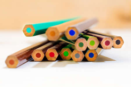 Colour pencils on white and wooden background close up. Selective depth of fieldの写真素材