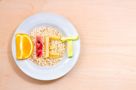 white plate with the word diet of different fruits on a wooden tableの写真素材