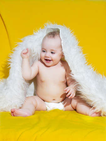 smiling baby on yellow blanketの写真素材