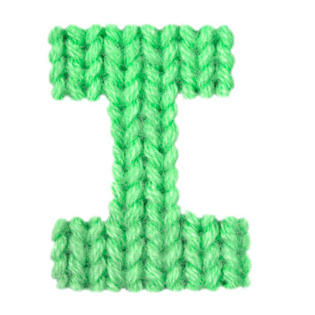 Letter I alphabet on a blurry texture knitted pattern of woolen thread closeup. One letter of the English alphabet. Education and holidays. Typography design. Color greenの写真素材