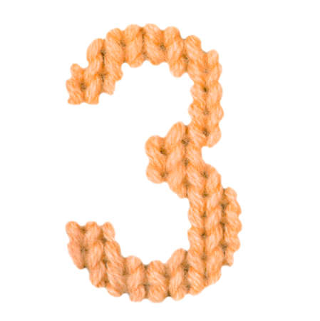 Number 3 (three) alphabet on a blurry texture knitted pattern of woolen thread closeup. One figure of the alphabet. Education and holidays. Typography design. Color orangeの写真素材