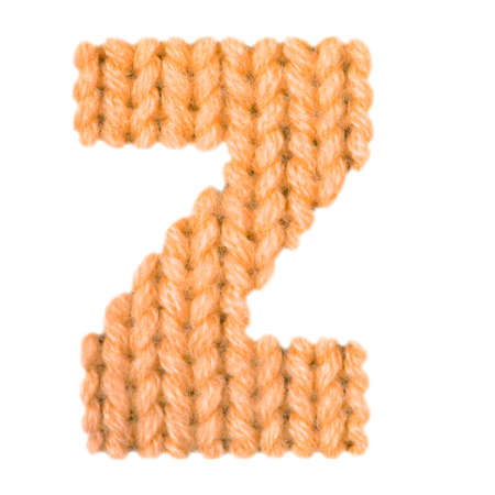 Letter Z alphabet on a blurry texture knitted pattern of woolen thread closeup. One letter of the English alphabet. Education and holidays. Typography design. Color orangeの写真素材