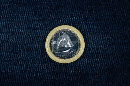Condom on blue jeansの写真素材
