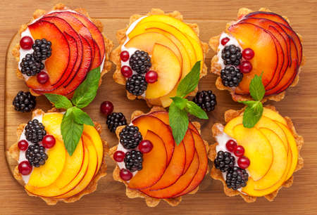 Tarts with froots on the wooden deskの写真素材