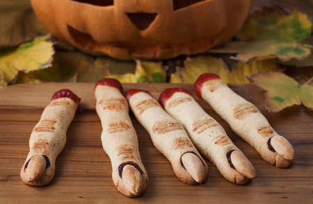 Halloween finger cookies on the wooden deskの写真素材