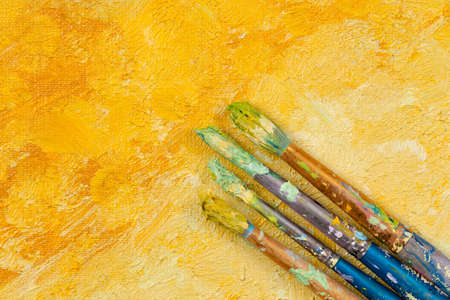 Artists vintage brushes on yellow artistic backgroundの写真素材