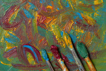 Impressionism art abstract background canvas oil painting with vintage artist paint brushesの写真素材