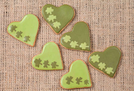 Patrick day cookies with clover on vintage textile backgroundの写真素材