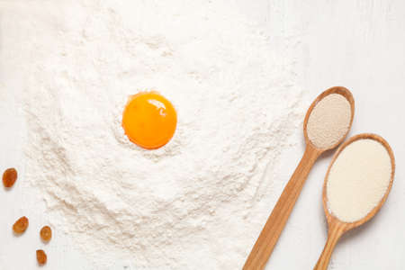 Pastry ingredients. Egg, flour and yeast on white rustic table backgroundの写真素材
