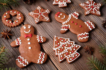 Gingerbread cookies man and woman couple christmas holiday composition with icing on vintage wooden...