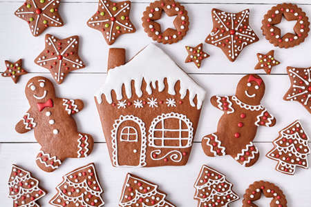 Gingerbreand cookies christmas composition, house man and woman couple, stars, fur trees on white...