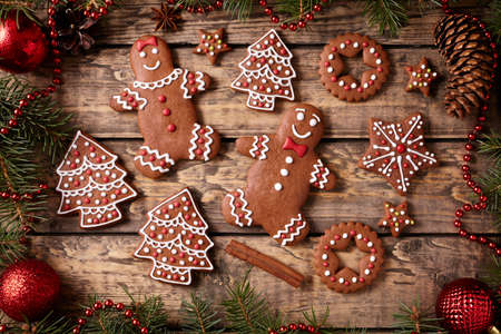 Gingerbread man and woman, fir trees, stars cookies christmas composition in new year decorations...