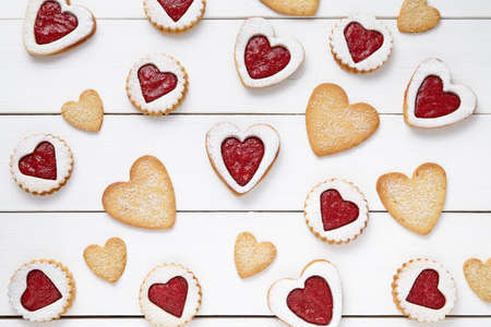 Heart shaped and shortbread cookies with jam gift composition for Valentines Day on vintage wooden background. Food concept of romantic love. Top view, flat lay.の写真素材