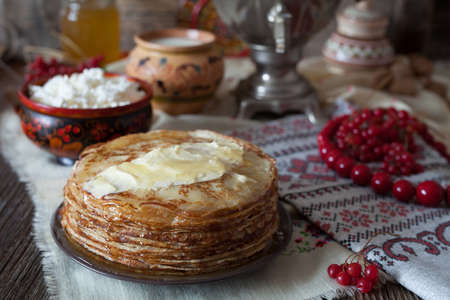 Homemade traditional pancakes with honey, butter and cottage cheese in rustic style on vintage wooden backgroundの写真素材