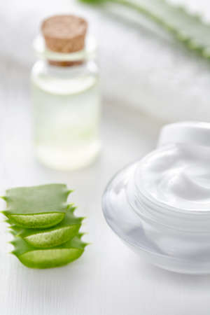 Aloe vera cosmetic cream in product container with glass bottle on white background.の写真素材