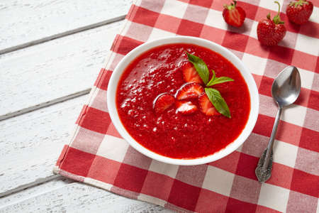 Strawberry soup healthy vegetarian summer fruit dessert food, vitamin rich nutrition meal on white vintage backgroundの写真素材